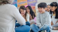 Preschool student smiles during circle time activities