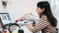 Girl watches a lesson at home on her laptop