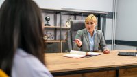 Administrator talks to student in her office