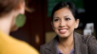 Smiling woman talks to a colleague