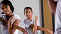 Elementary students stretching in class