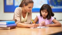 Elementary teacher holding a writing conference with a student