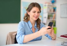 A teacher making a phone call on a cell phone