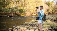 High school student studies ecology by river