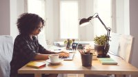 Woman working on laptop at home