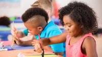 Elementary school students painting in art class at school