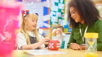 Elementary teacher works with a student using a math manipulative