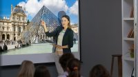 Teacher projects an image of the Louvre museum