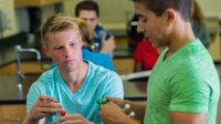 Two high school students working on a science project