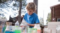 Boy does science experiment outside