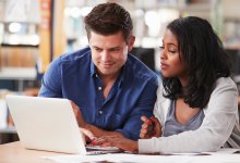 Two teachers collaborating on a lesson in the school library
