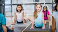Elementary students performing yoga poses