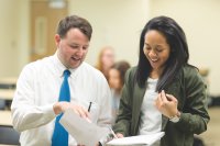 A teacher and an administrator looking over some paperwork together