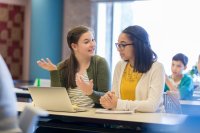 two students work together on a class assignment