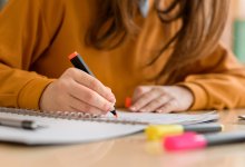 Student using a highlighter to take notes