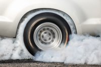 Spinning tires on a white car