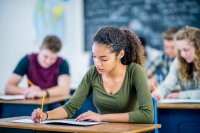 Female student sitting in a classroom taking a test