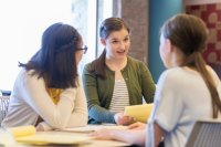 A group of middle school students working together on a math project