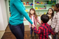 Teacher dancing with kindergarten students