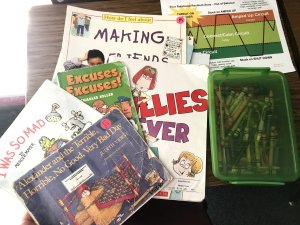 A collection of children's books on emotions on a school desk