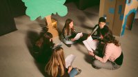 Middle school students rehearsing for school play in drama class