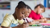 Elementary students writing in classroom