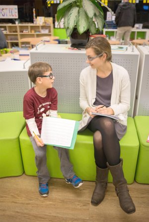 A young boy talks with the writer of this article about his work.