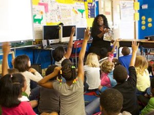 Teacher calling on students with their hands raised