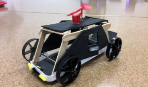 A vehicle created from a plastic tray, foam, and popsicle sticks