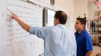 photo of teacher and student at whiteboard