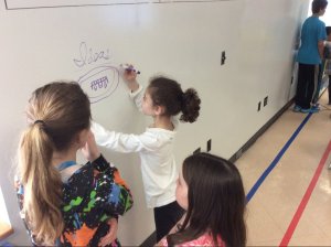 Children using wall covered in idea paint