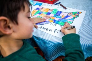 Child coloring a map of the U.S.