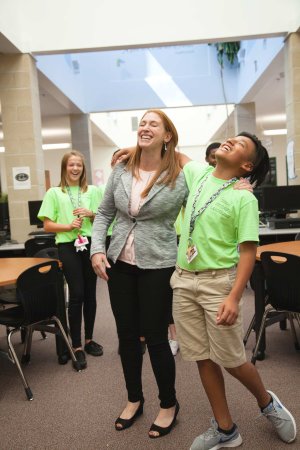 Administrator laughs with student. 