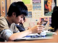 Boy in class using a tablet