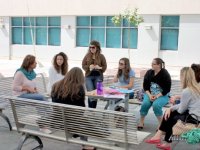 photo of a group of people sitting on benches in a circle