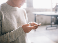 A photo of a high school student using a smartphone.