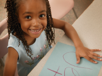 A photo of an elementary-school girl practicing writing.