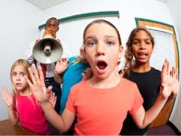 Teacher with blow horn and students with raised hands