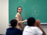 Teacher at the chalkboard looking toward students