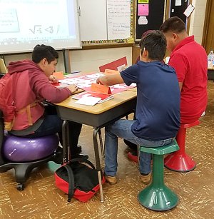 Students sit on balance balls and active learning stools in class.