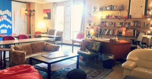 A classroom with couches, lounge chairs, a coffee table, and a bean bag chair