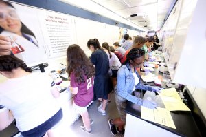 Students are working inside of a semi-truck that was converted into a science lab.