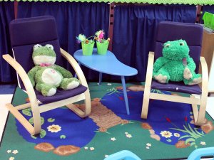 Two small rocking chairs on a carpet