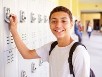 Boy at his locker outside hallway