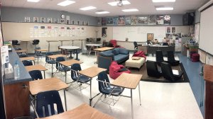 A classroom split between rows of desks and flexible furniture, like couches and standing desks.