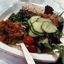 A photo of a salad with colorful side dishes.