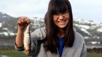 Girl from Alaska's Chugach School District holding up a fish