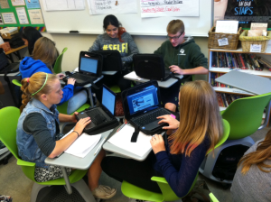 Students working together in rolling chairs