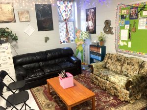 A lounge area in a classroom with couches and a coffee table