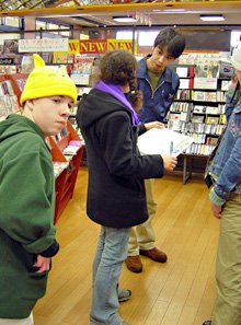 Students in a store speaking with the clerk.